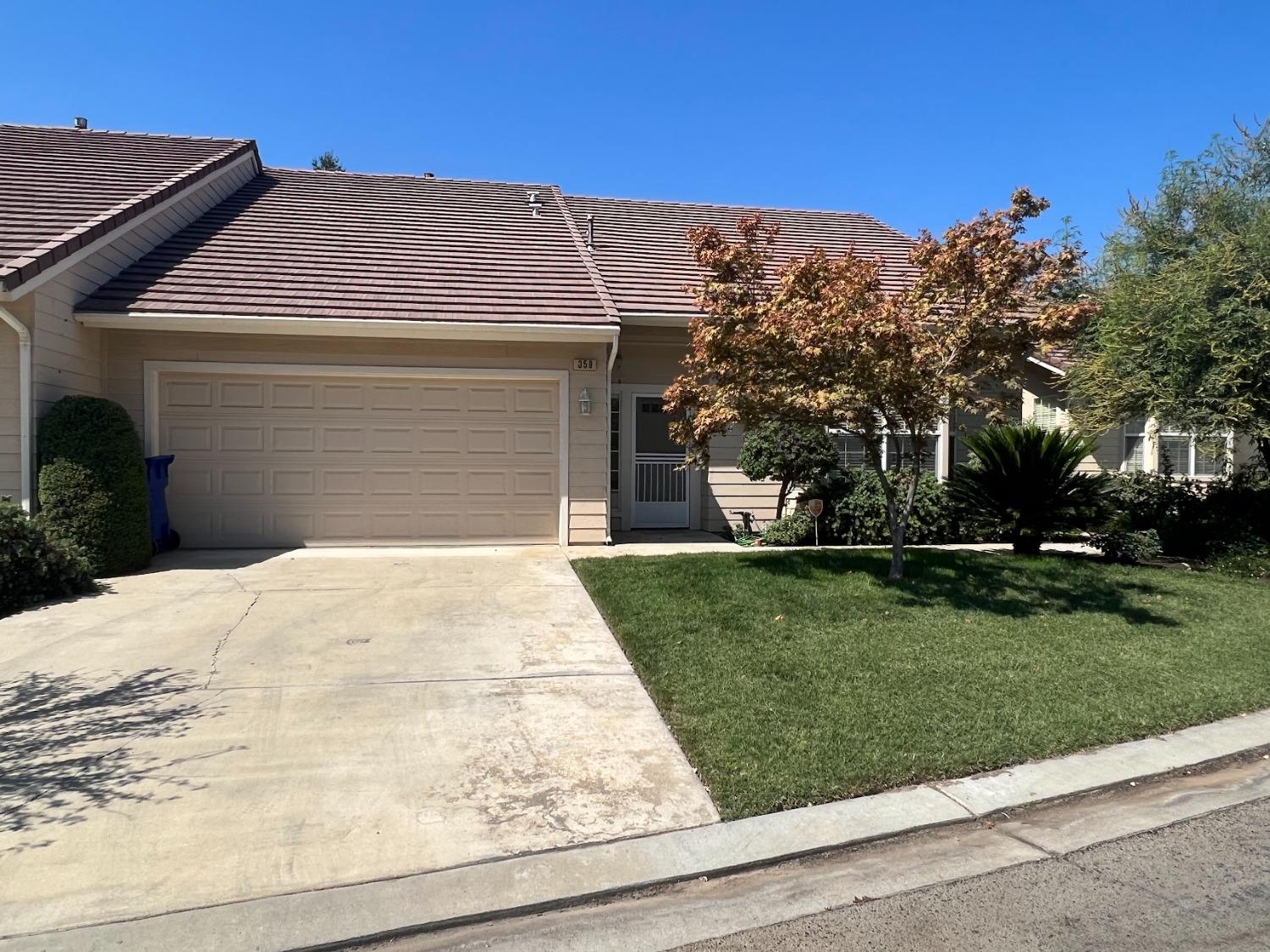 Undisclosed Address Dinuba, CA 93618 - Photo 3 of 45 a front view of a house with a yard