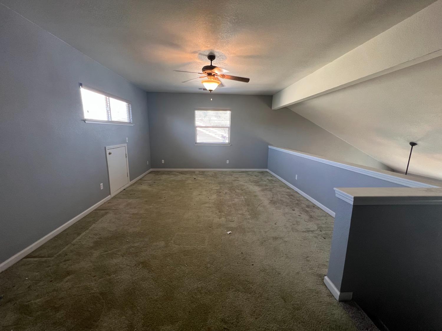 Undisclosed Address Dinuba, CA 93618 - Photo 34 of 45 a view of an empty room and window and chandelier fan
