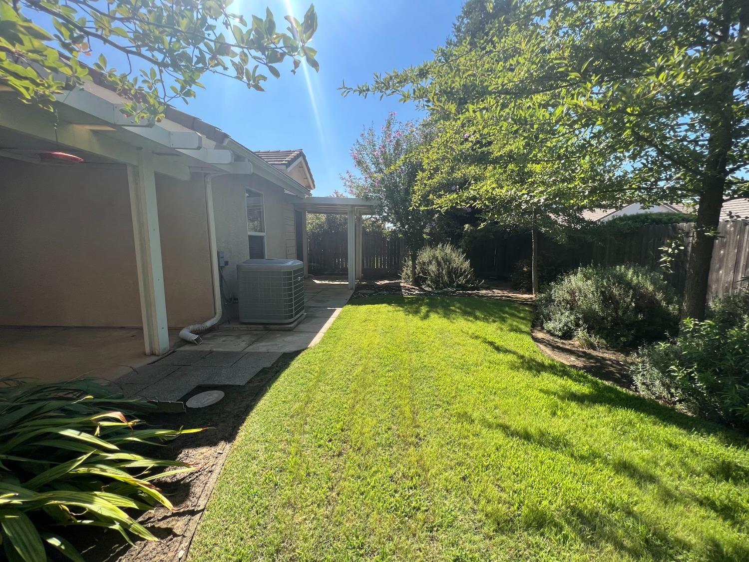 Undisclosed Address Dinuba, CA 93618 - Photo 44 of 45 a backyard of a house with fountain table and chairs