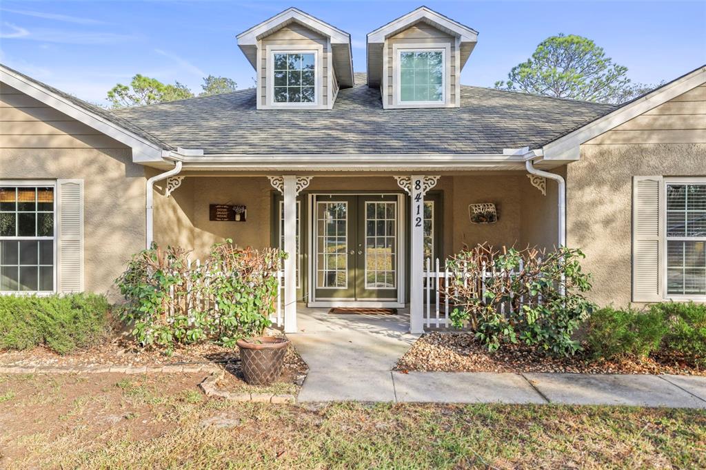 8412 Christopher Lane Weeki Wachee, FL 34613 - Photo 39 of 41 a front view of a house with garden