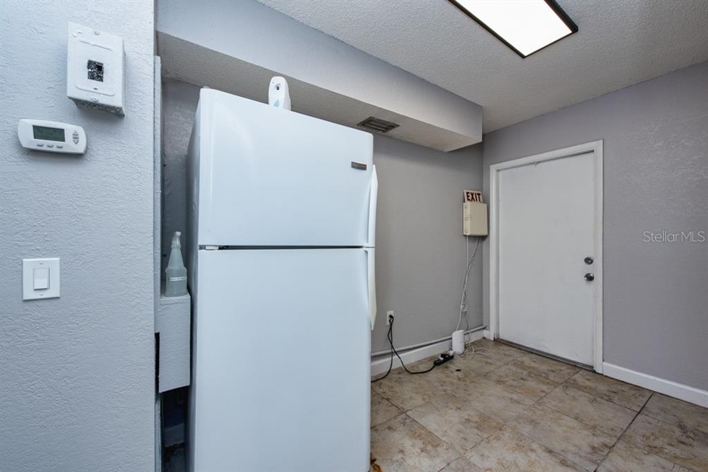 7410 Commerce Street, Unit 101 Riverview, FL 33578 - Photo 12 of 25 a view of a refrigerator in kitchen and an empty room