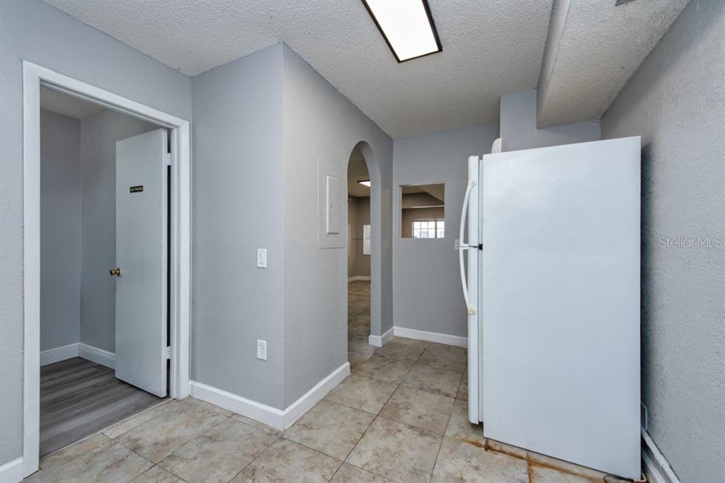 7410 Commerce Street, Unit 101 Riverview, FL 33578 - Photo 13 of 25 a view of a hallway with wooden cabinets