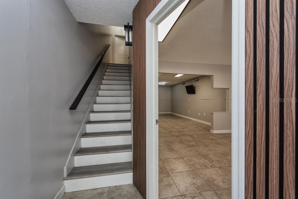 7410 Commerce Street, Unit 101 Riverview, FL 33578 - Photo 4 of 25 a view of entryway with wooden floor and stairs