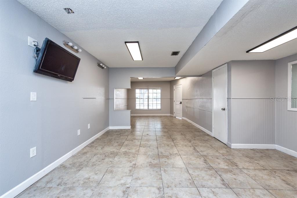 7410 Commerce Street, Unit 101 Riverview, FL 33578 - Photo 10 of 25 a view of empty room with flat screen tv and outdoor space