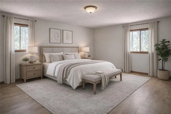 a spacious bedroom with a bed and a window