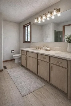a spacious bathroom with a granite countertop sink a toilet and mirror