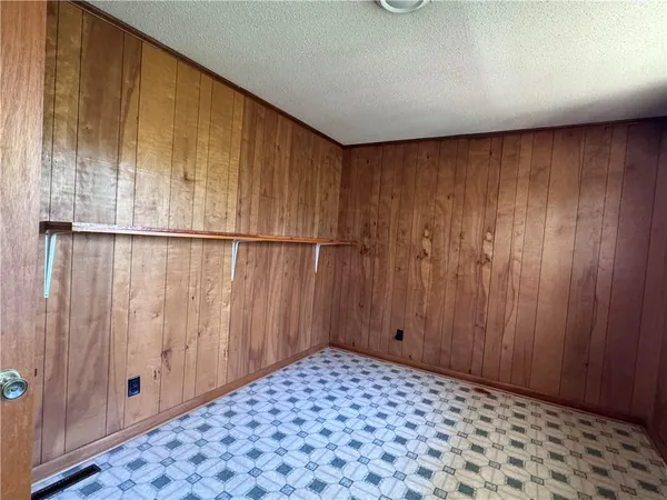 a view of a room with a wooden door