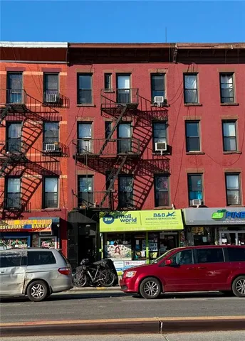 a view of a cars park in front of a building