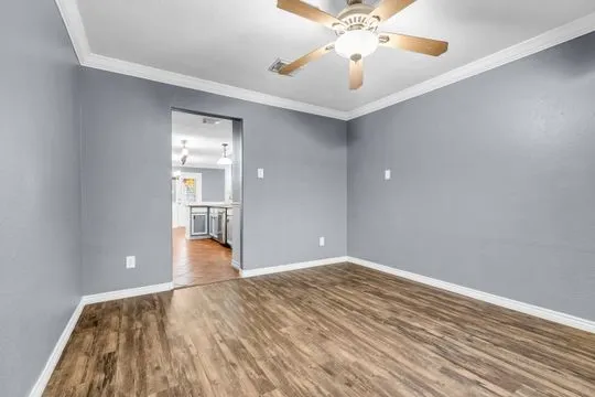 wooden floor in an empty room with a window