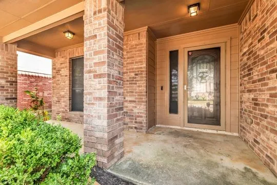 front view of a brick house with a large windows