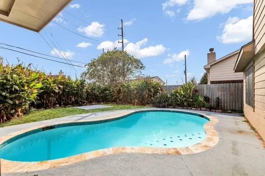 a view of a swimming pool with a yard