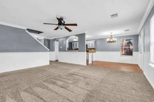 a view of a kitchen with a sink and white cabinets