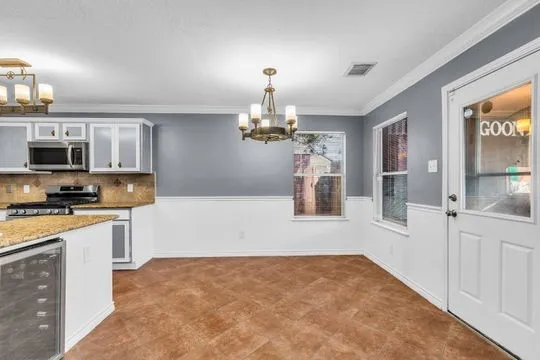 a kitchen with kitchen island a sink stainless steel appliances and cabinets