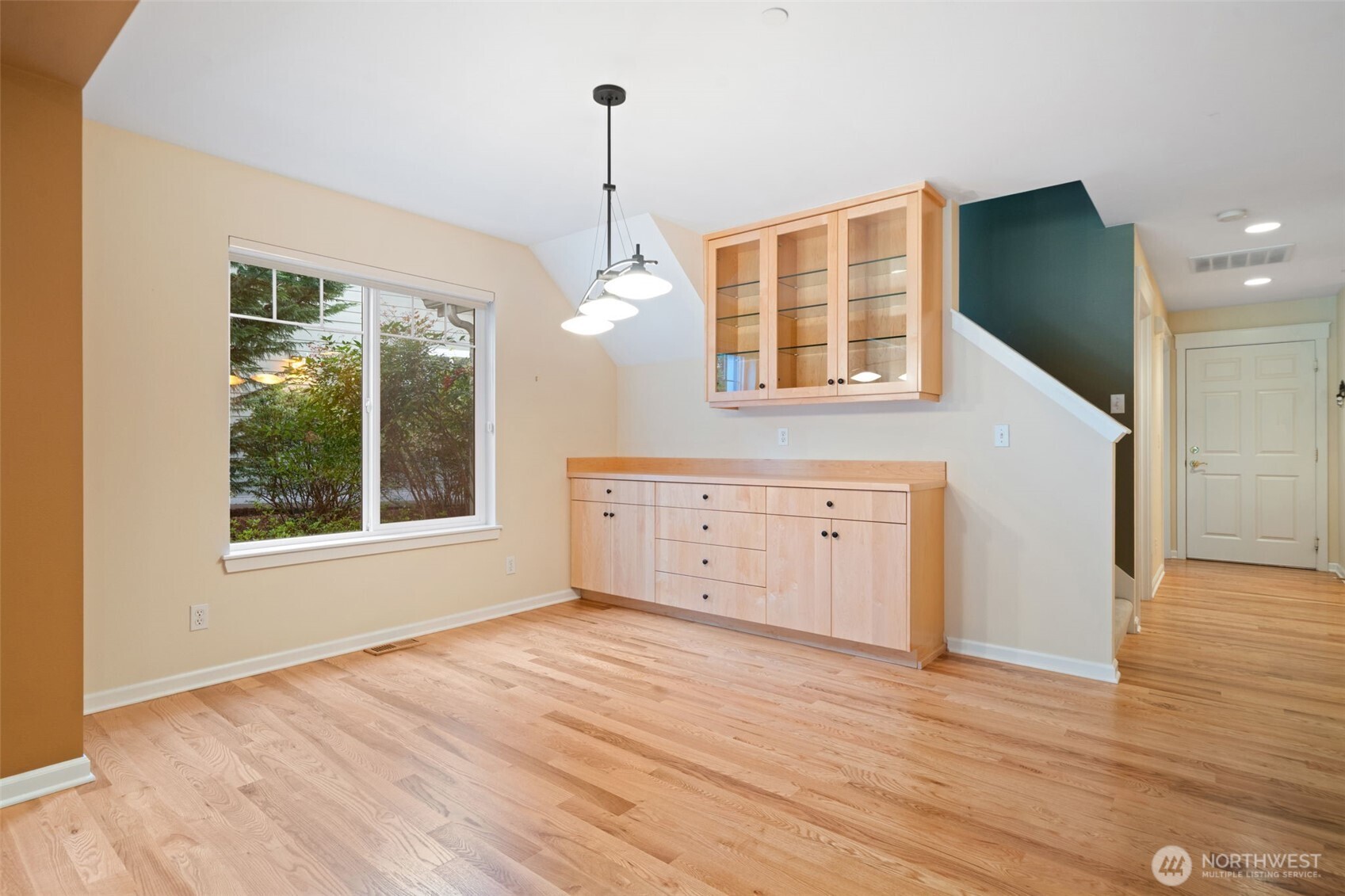 321 East Soderberg Road, Unit D12 Allyn, WA 98524 - Photo 14 of 37 a view of an empty room with wooden floor and a window