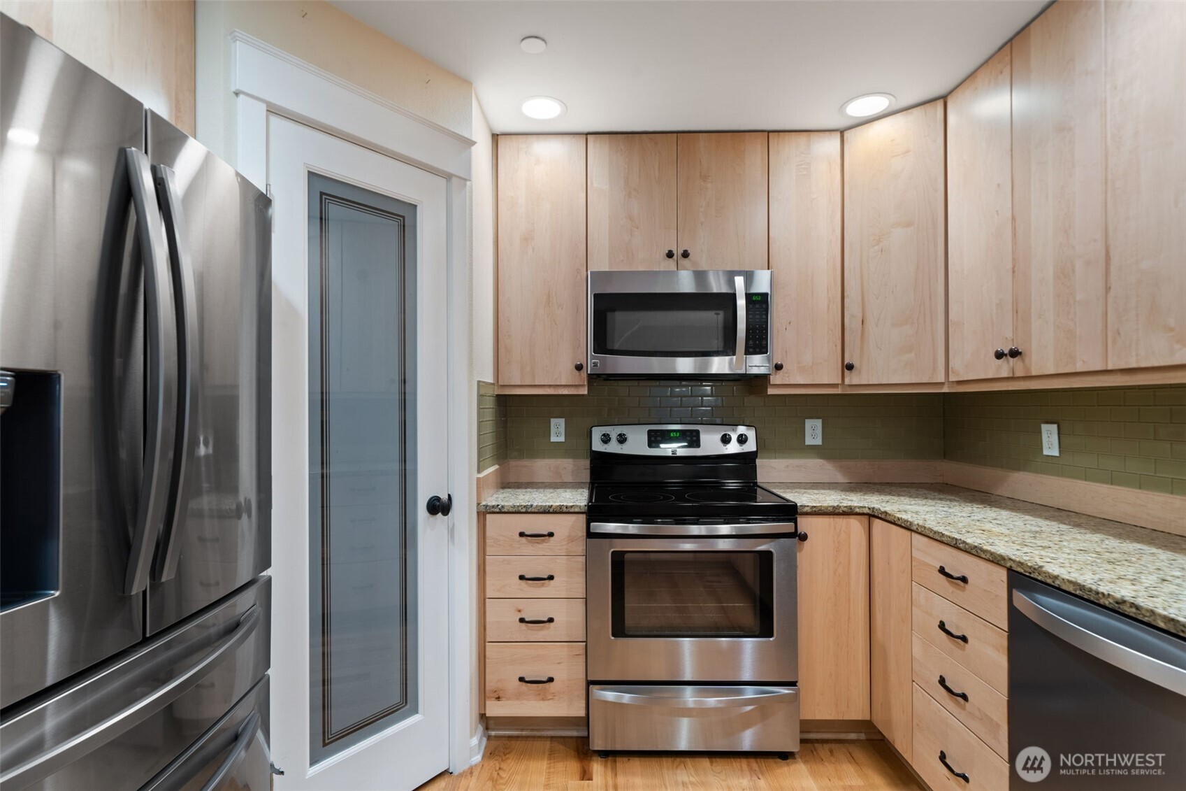 321 East Soderberg Road, Unit D12 Allyn, WA 98524 - Photo 18 of 37 a kitchen with stainless steel appliances and white cabinets