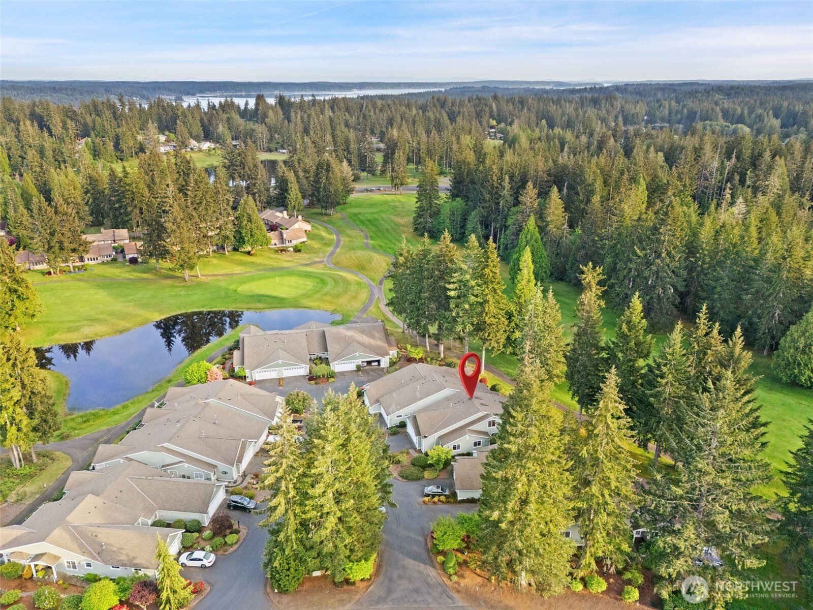 321 East Soderberg Road, Unit D12 Allyn, WA 98524 - Photo 3 of 37 an aerial view of a house with garden space and outdoor seating