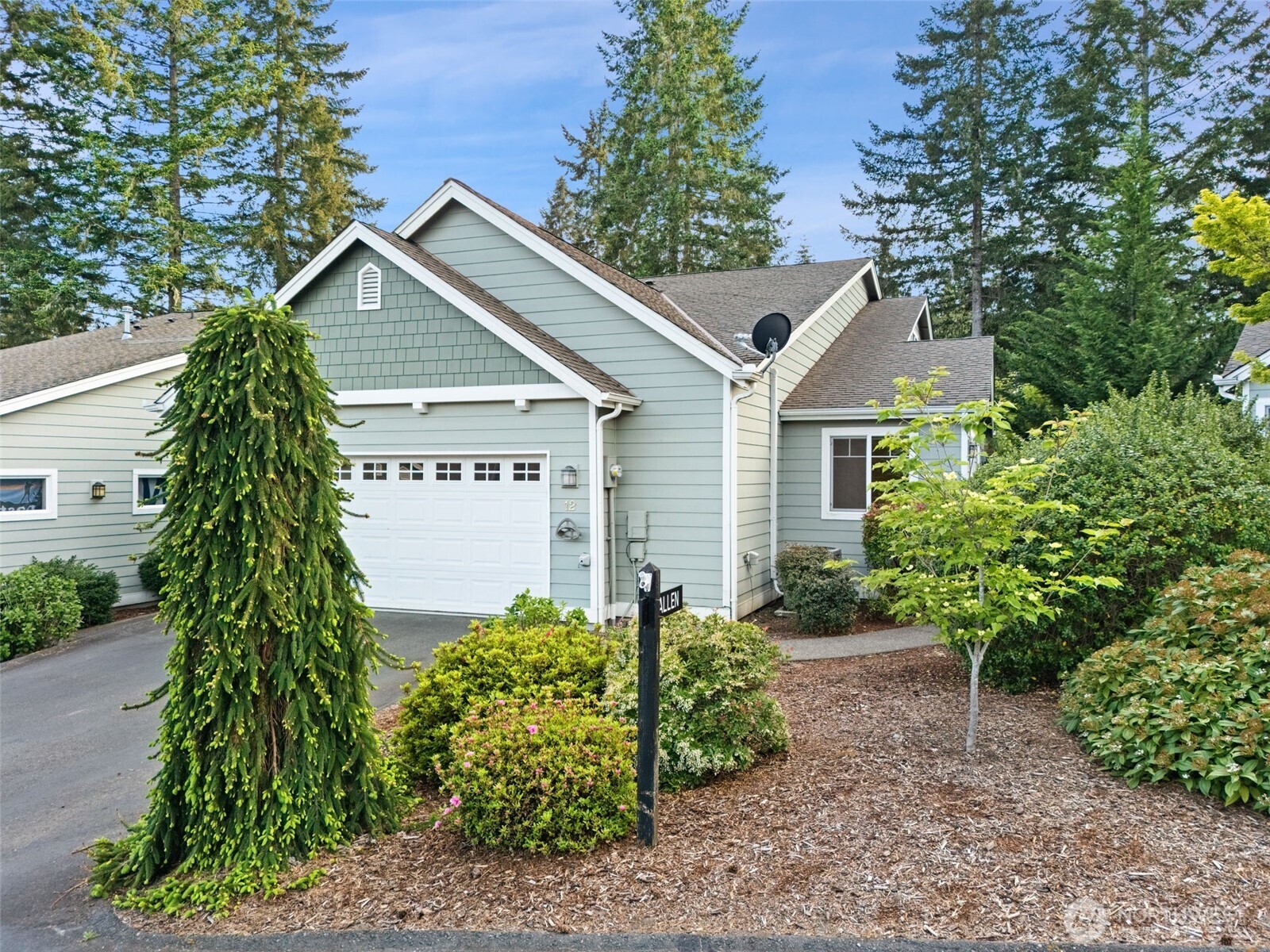 321 East Soderberg Road, Unit D12 Allyn, WA 98524 - Photo 33 of 37 a view of a house with a yard and potted plants
