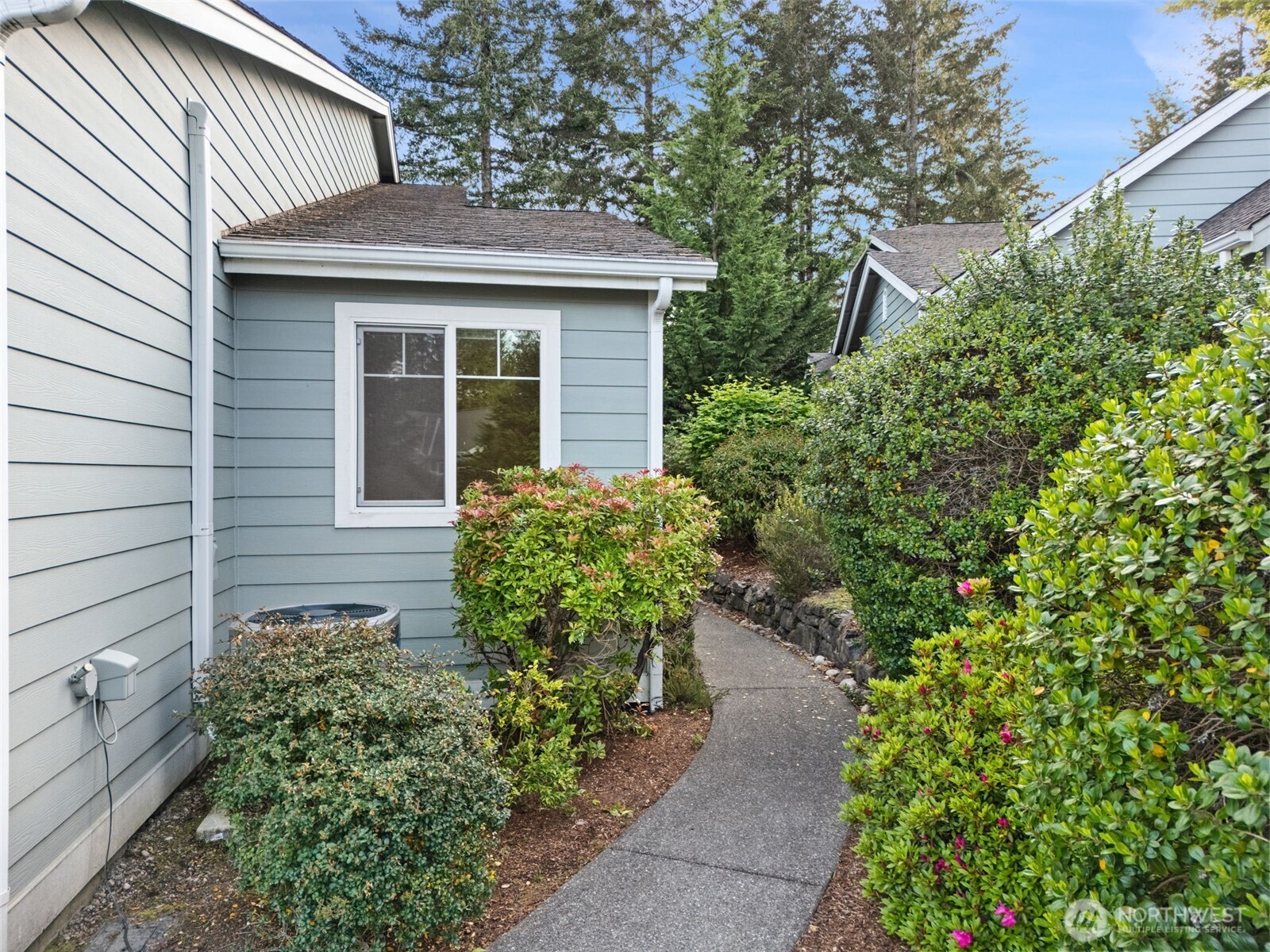 321 East Soderberg Road, Unit D12 Allyn, WA 98524 - Photo 4 of 37 a front view of a house with a yard