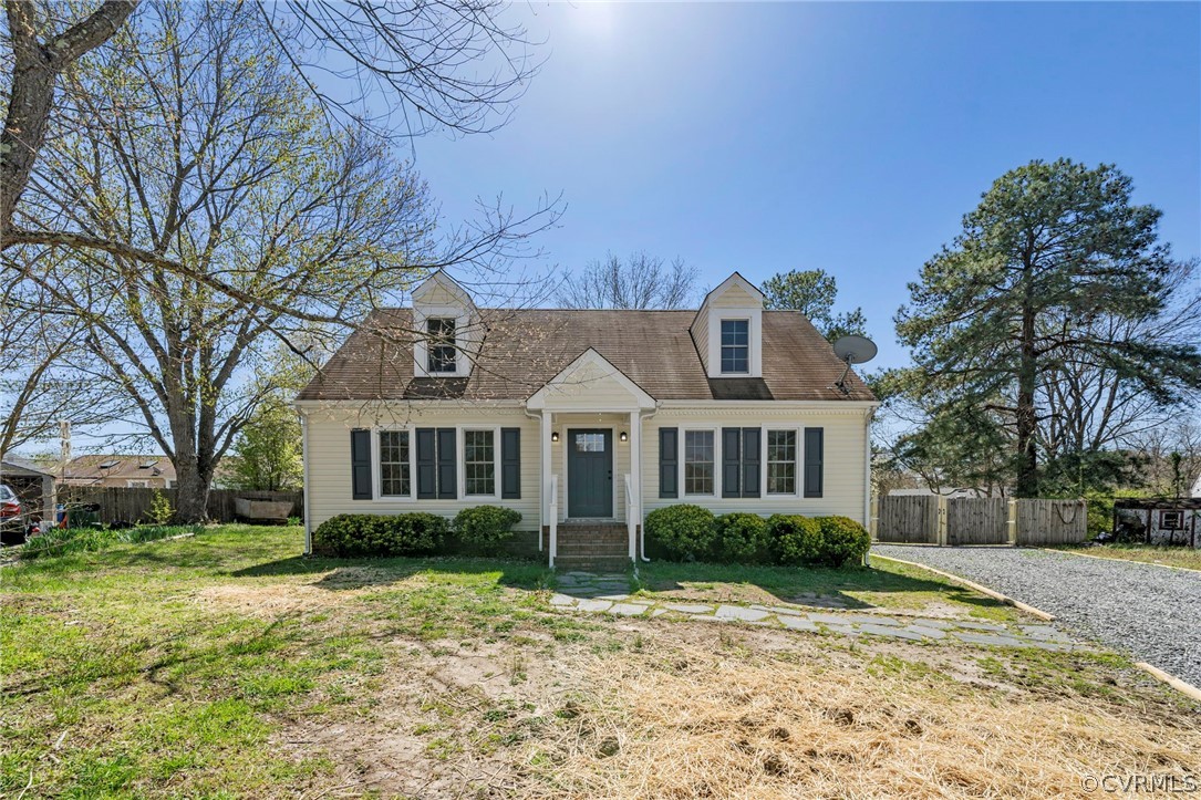a front view of house with yard and trees around