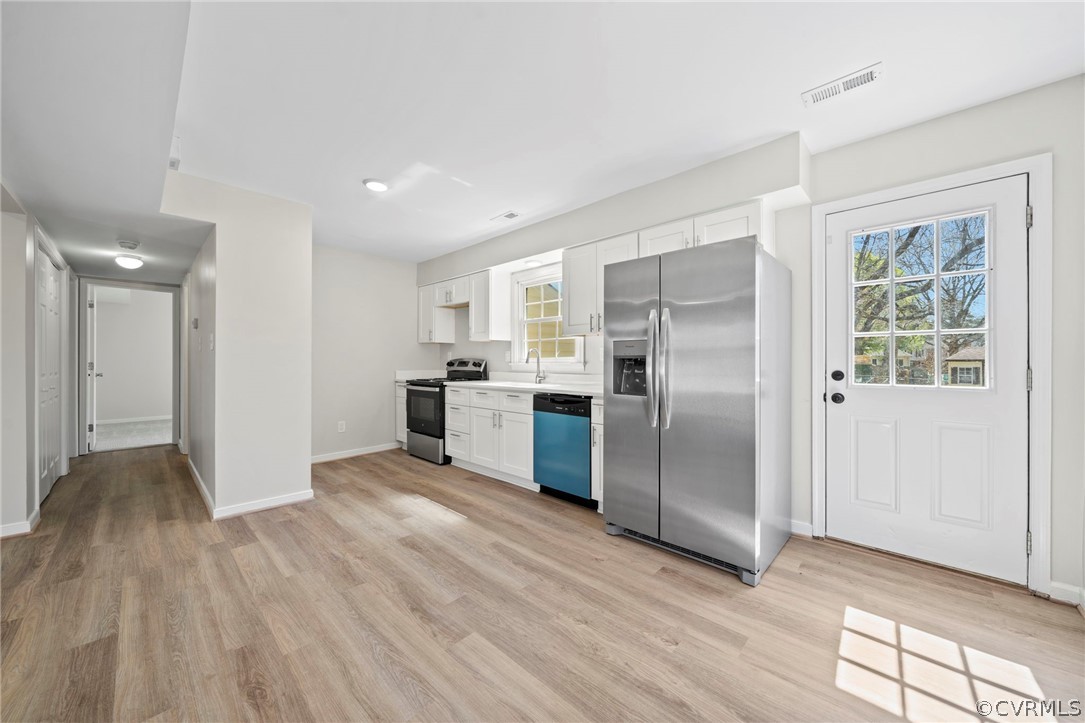 5205 Hallmark Circle Richmond, VA 23234 - Photo 6 of 36 a view of a kitchen with wooden floor electronic appliances and windows