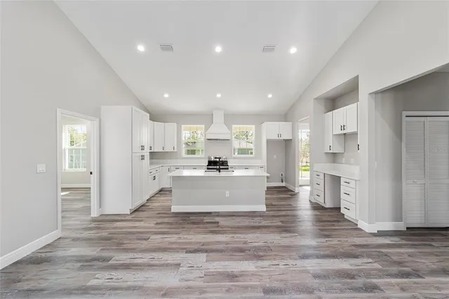 a view of kitchen with stainless steel appliances refrigerator oven and cabinets