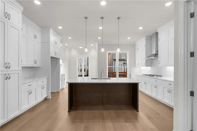 a large kitchen with granite countertop a large counter top covered stainless steel appliances and cabinets