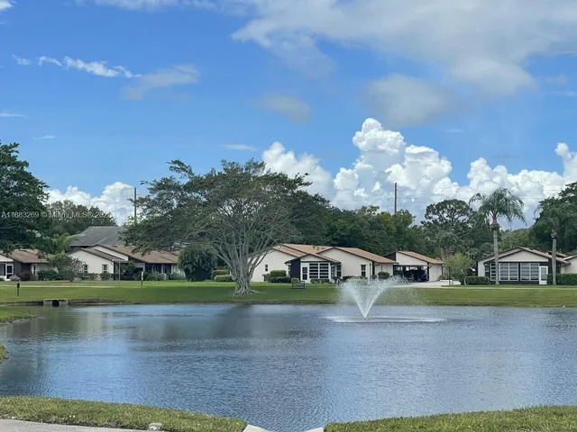 a view of a lake with houses in the back