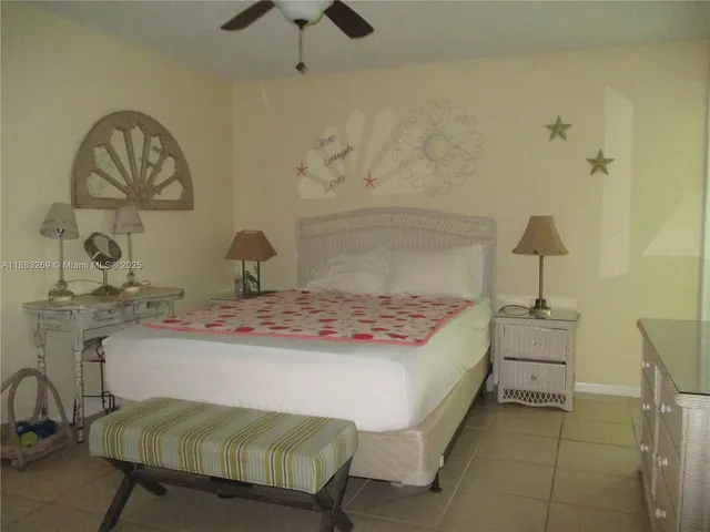 a bedroom with a bed and chandelier