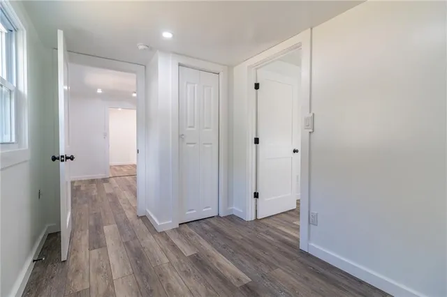 a view of a hallway with wooden floor