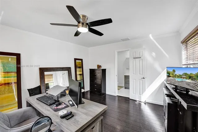 a view of a swimming pool with a lounge chair and palm trees