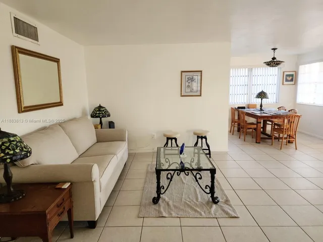 a living room with furniture and a dining table