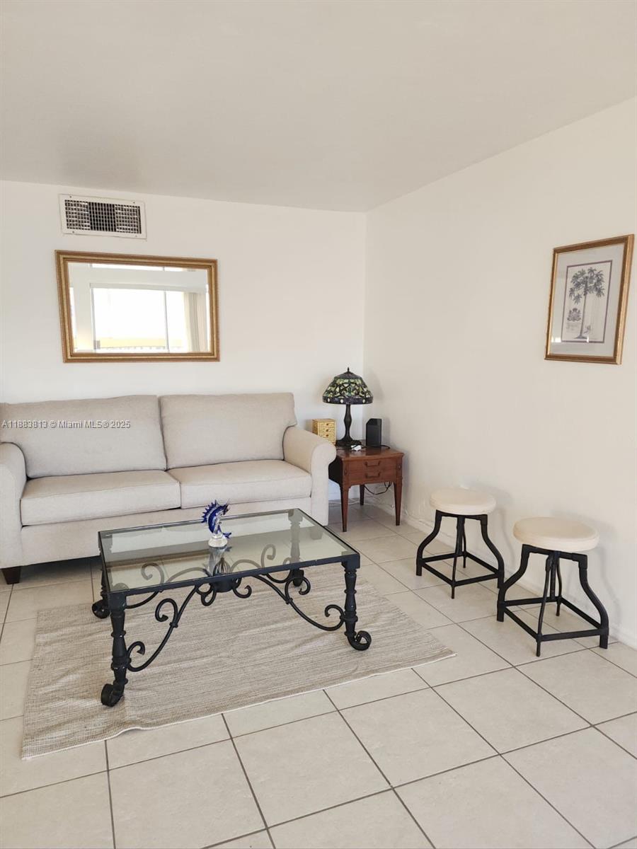 11960 Northeast 19th Drive, Unit 10 North Miami, FL 33181 - Photo 15 of 40 a living room with furniture