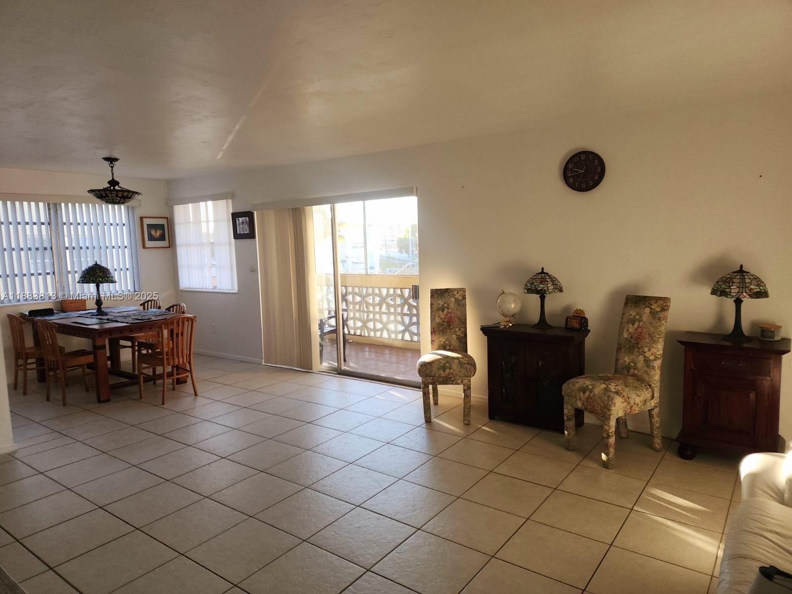 11960 Northeast 19th Drive, Unit 10 North Miami, FL 33181 - Photo 17 of 40 a view of a workspace with furniture and a window