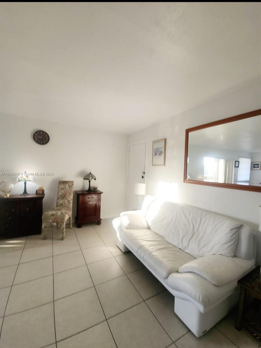 11960 Northeast 19th Drive, Unit 10 North Miami, FL 33181 - Photo 18 of 40 a living room with furniture and a couch