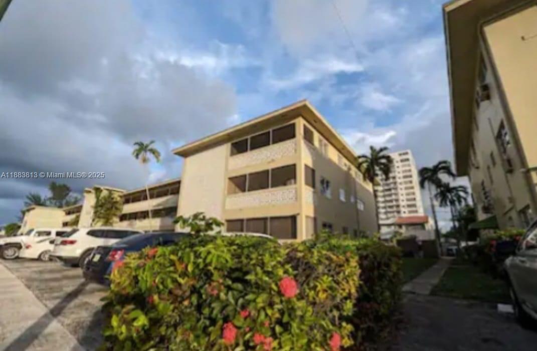 11960 Northeast 19th Drive, Unit 10 North Miami, FL 33181 - Photo 2 of 40 a house view with a outdoor space