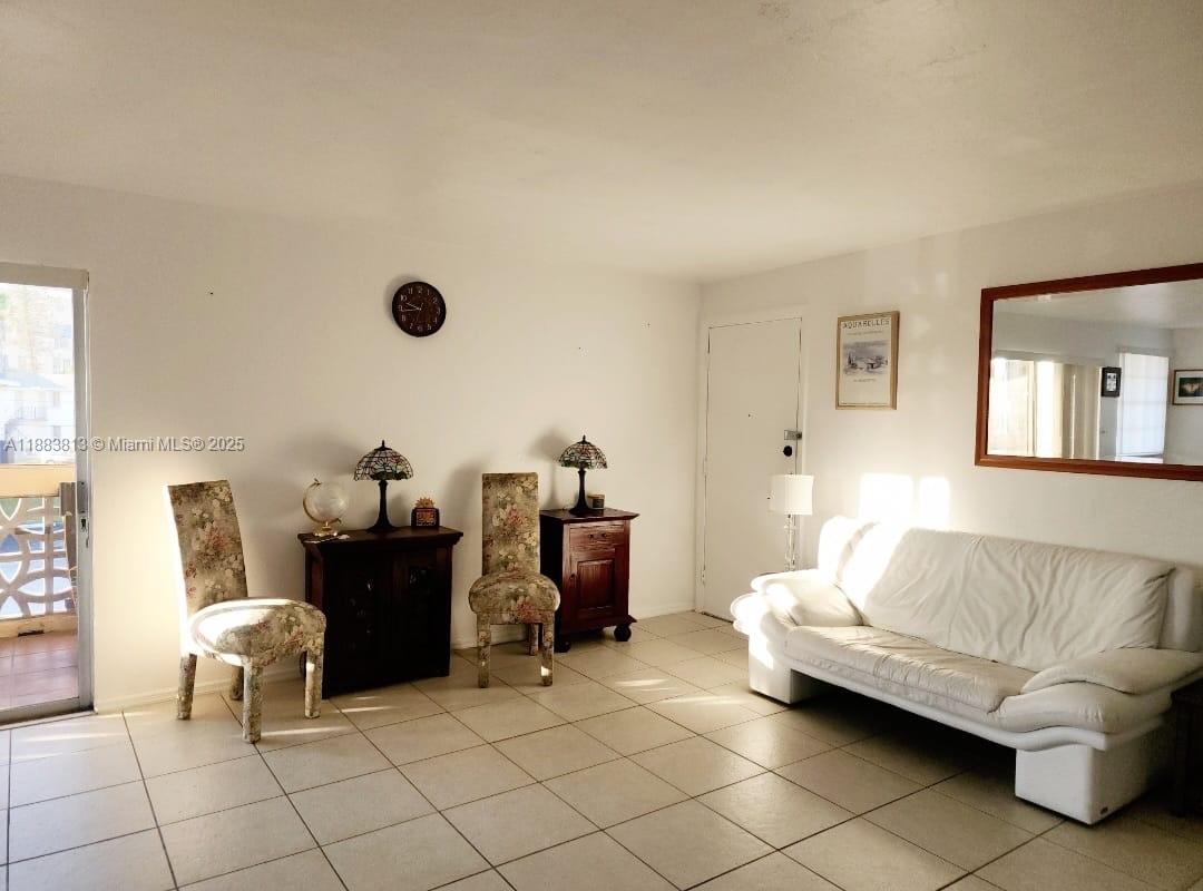 11960 Northeast 19th Drive, Unit 10 North Miami, FL 33181 - Photo 21 of 40 a living room with furniture and a table