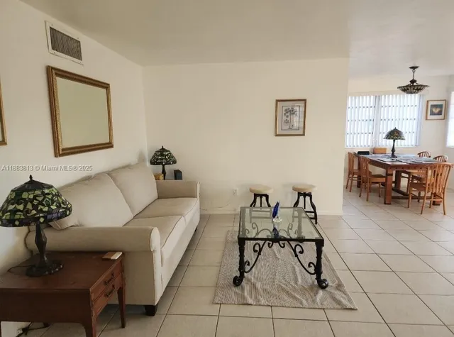 a living room with furniture and white walls