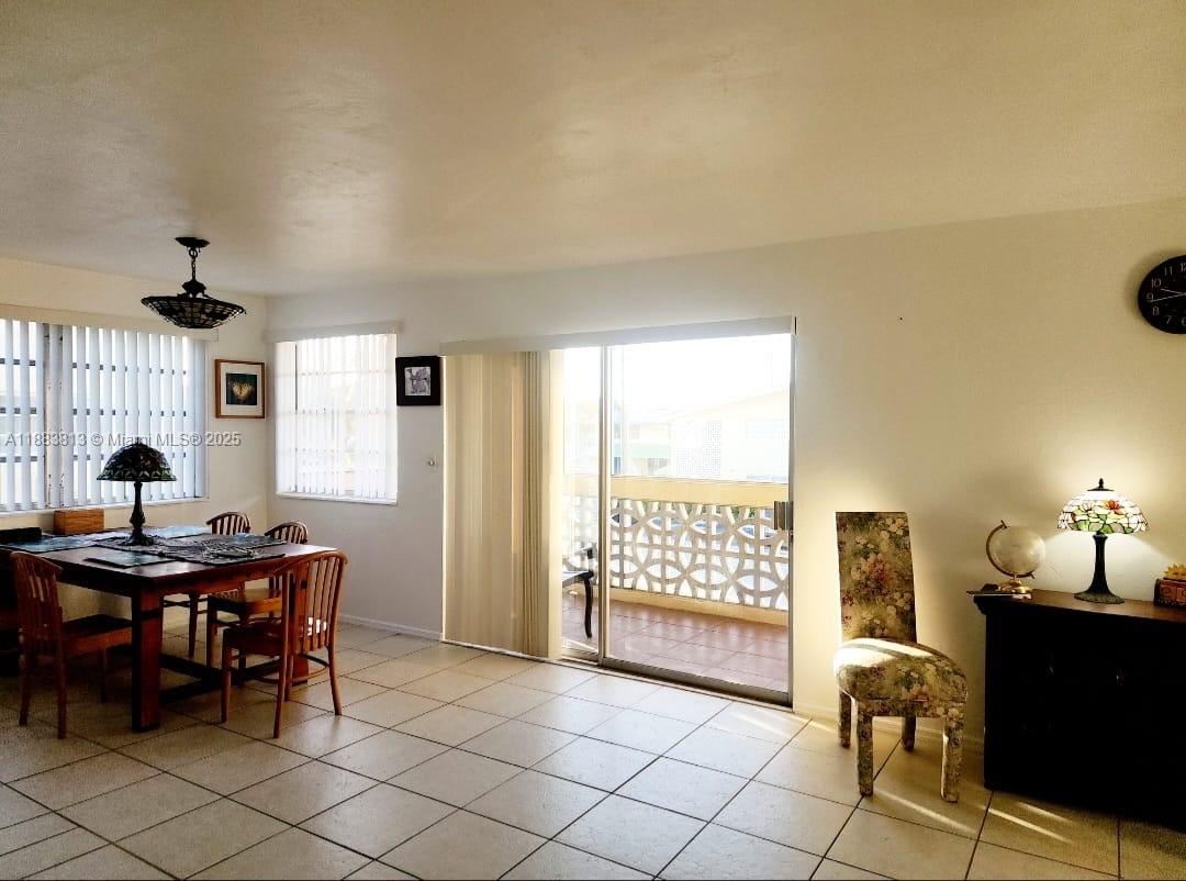 11960 Northeast 19th Drive, Unit 10 North Miami, FL 33181 - Photo 25 of 40 a view of a workspace with furniture and a window