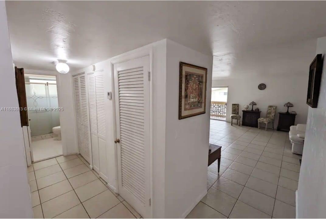 11960 Northeast 19th Drive, Unit 10 North Miami, FL 33181 - Photo 32 of 40 a en suite bathroom with a toilet a sink and mirror