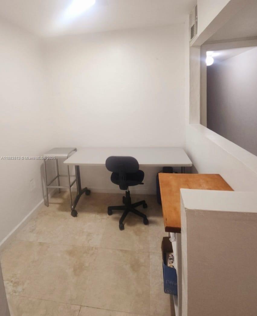 11960 Northeast 19th Drive, Unit 10 North Miami, FL 33181 - Photo 40 of 40 a work room with furniture and a lamp