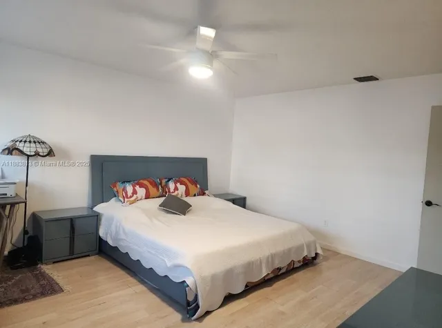 a bedroom with a bed and a night stand