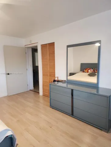 a room with a bed and a dresser