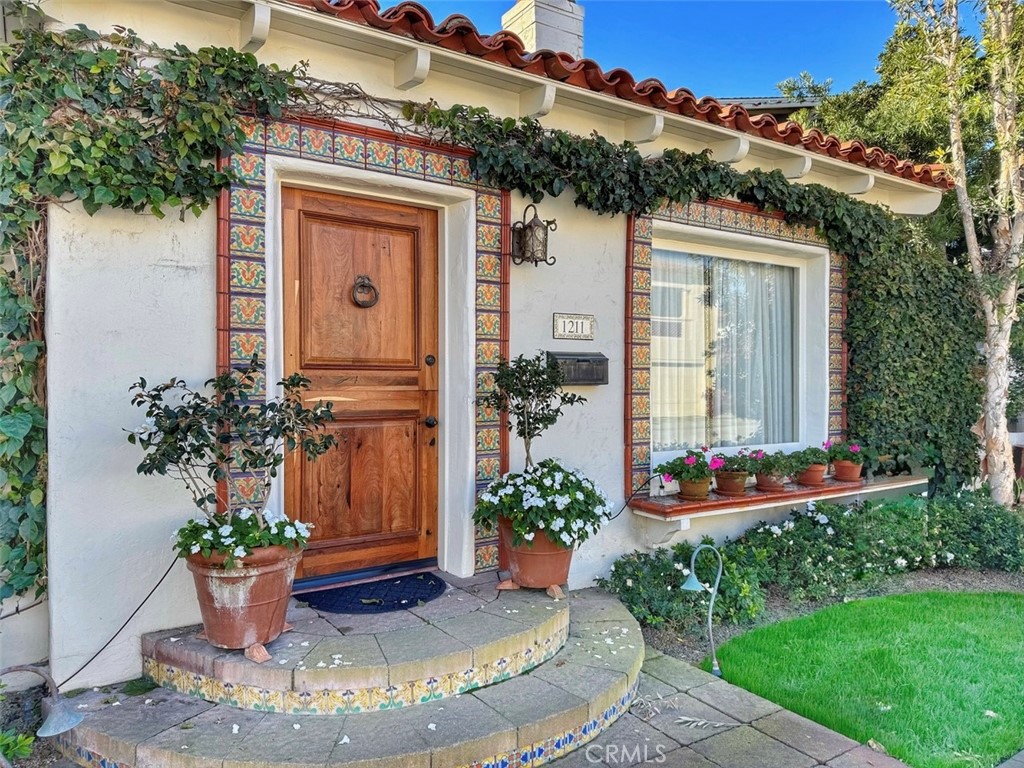 a view of a house with potted plants