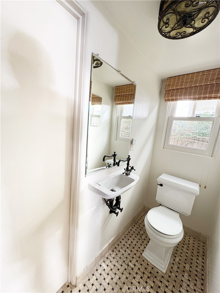 1211 West Bay Avenue Newport Beach, CA 92661 - Photo 13 of 29 a bathroom with a toilet a sink and a window