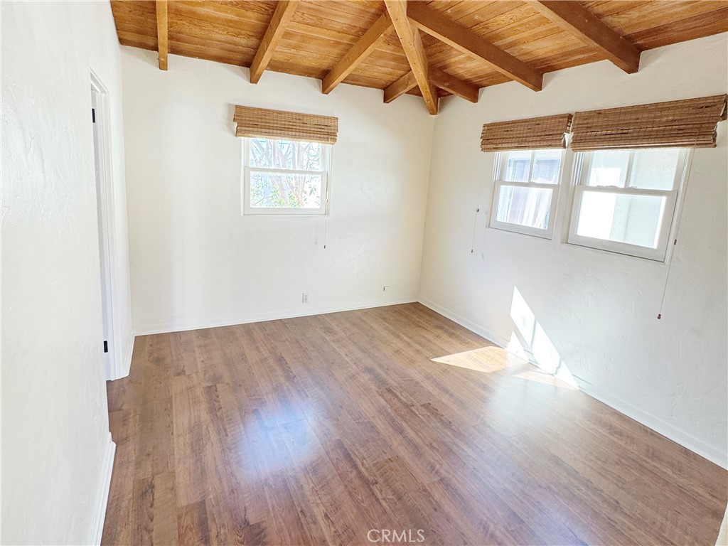 1211 West Bay Avenue Newport Beach, CA 92661 - Photo 15 of 29 an empty room with wooden floor and windows