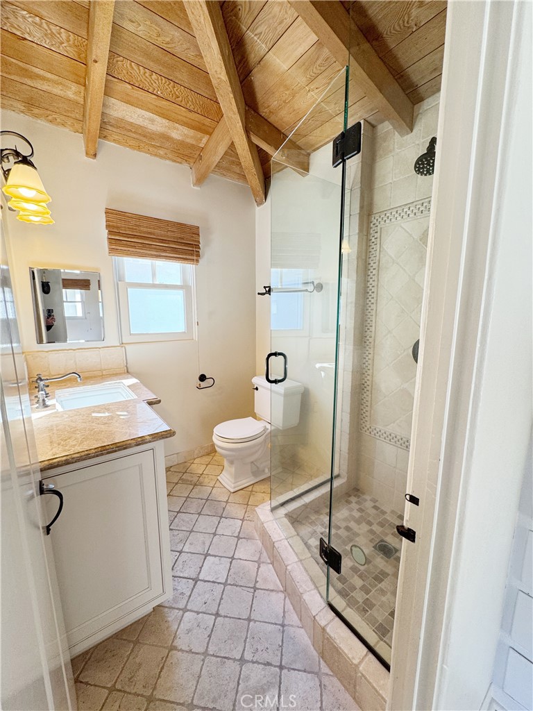 1211 West Bay Avenue Newport Beach, CA 92661 - Photo 16 of 29 a bathroom with a granite countertop sink a toilet and shower