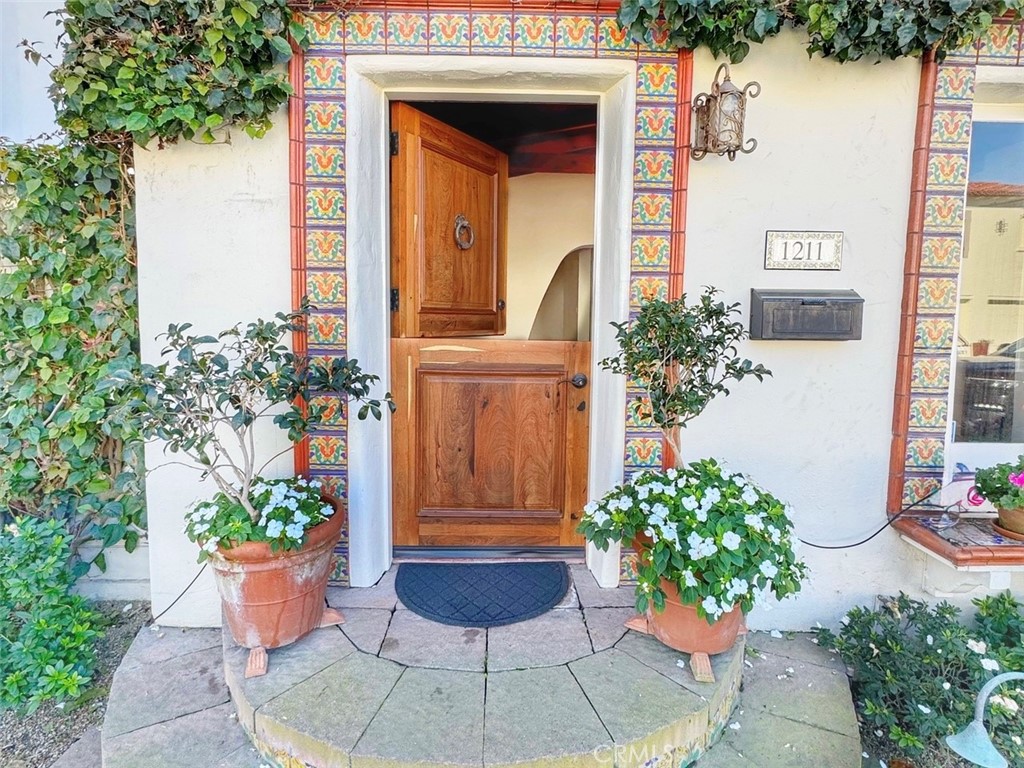 1211 West Bay Avenue Newport Beach, CA 92661 - Photo 2 of 29 a view of a entryway door of the house with potted plants
