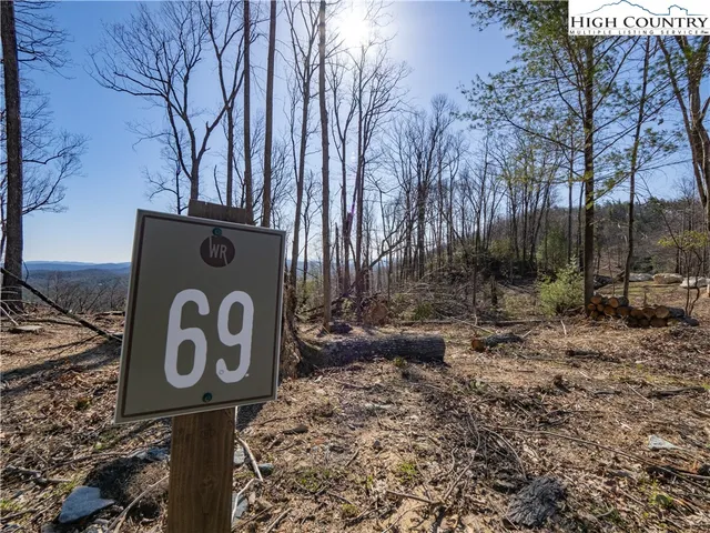 a street sign that is sitting on a rock