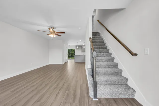 a view of entryway and hall with wooden floor