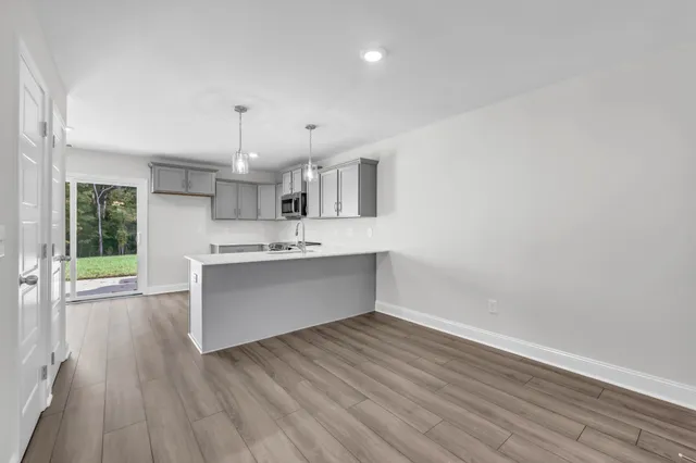 a kitchen with a wooden floor and window
